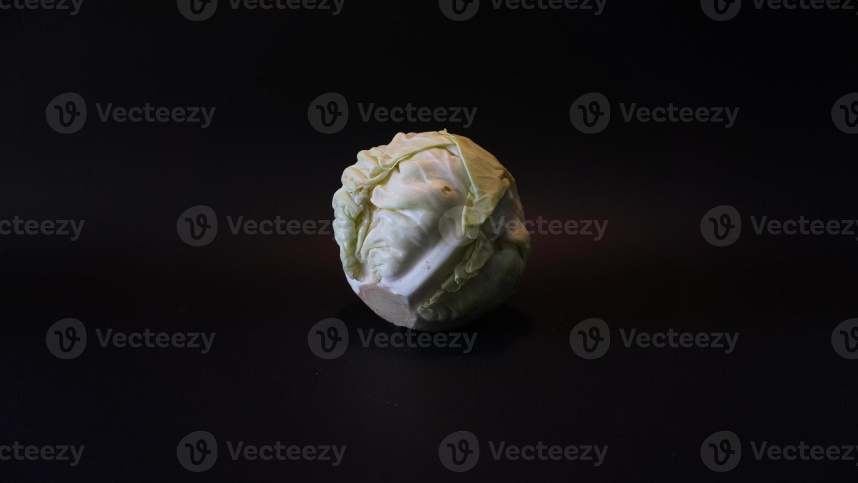 Fresh pointed white cabbage on black background. photo