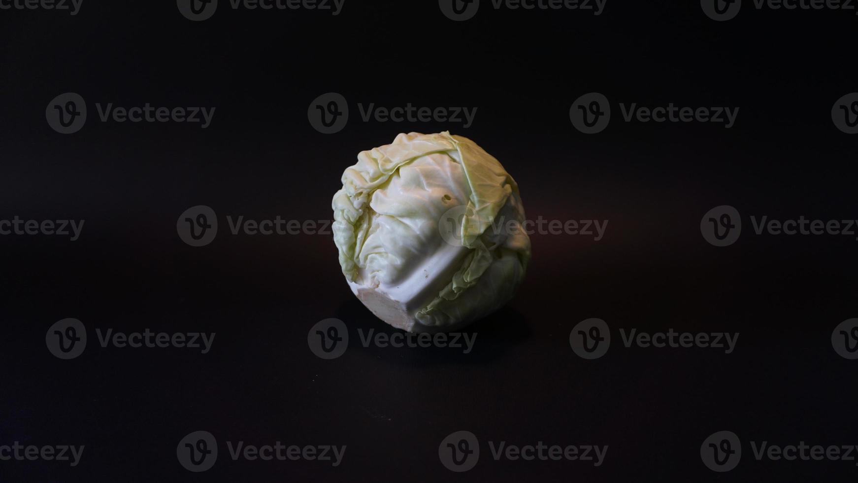 Fresh pointed white cabbage on black background. photo