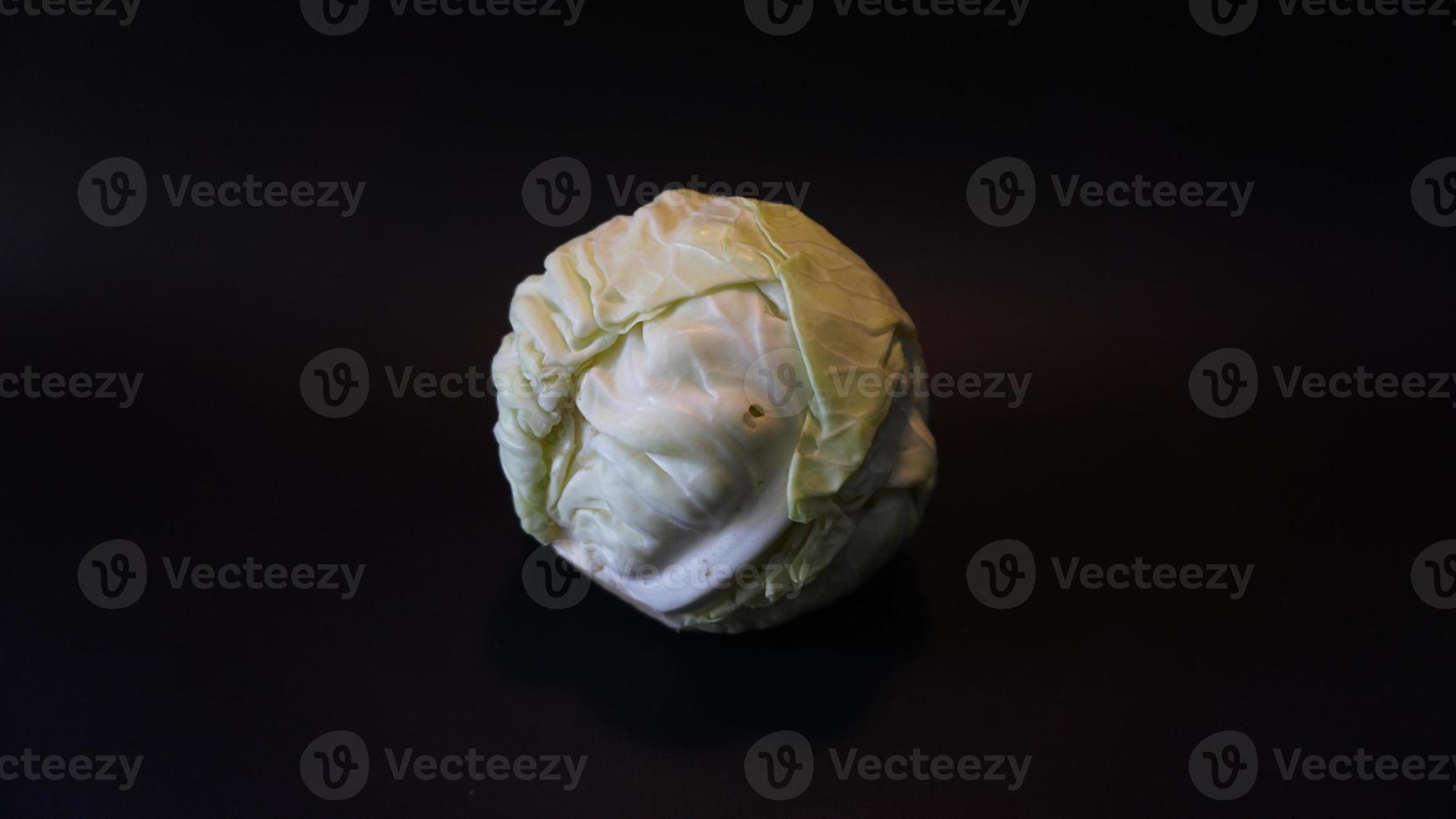 Fresh pointed white cabbage on black background. photo