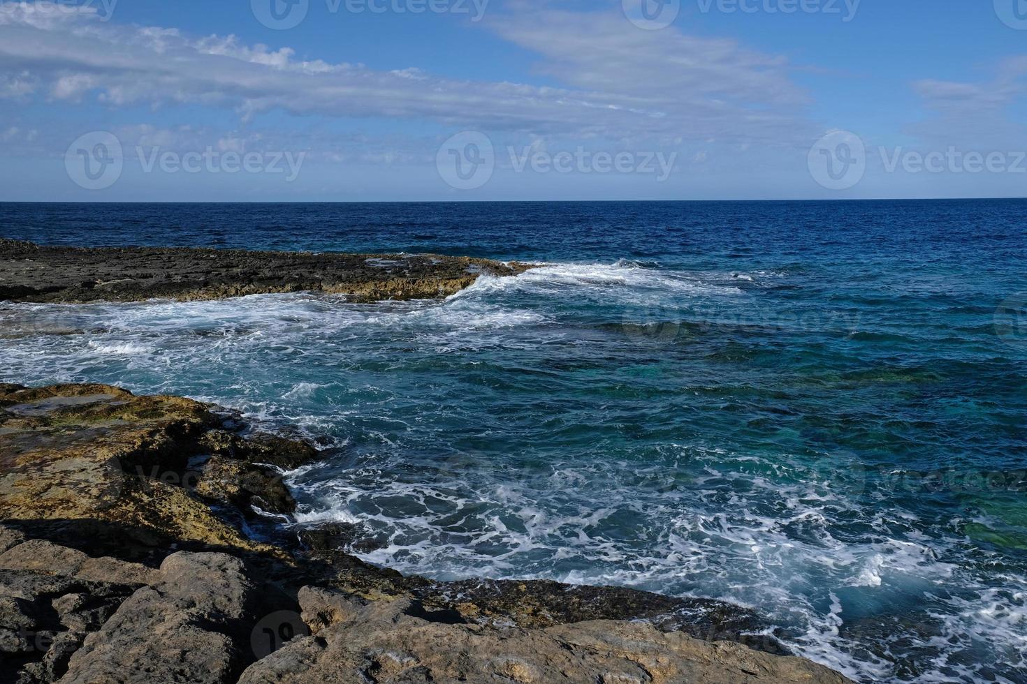 Blue sea wave and white foam. Stone beach on the island of Malta, no sandy beach. Summer holiday border frame concept. Tropical island vacation backdrop. Tourist travel banner design template. photo