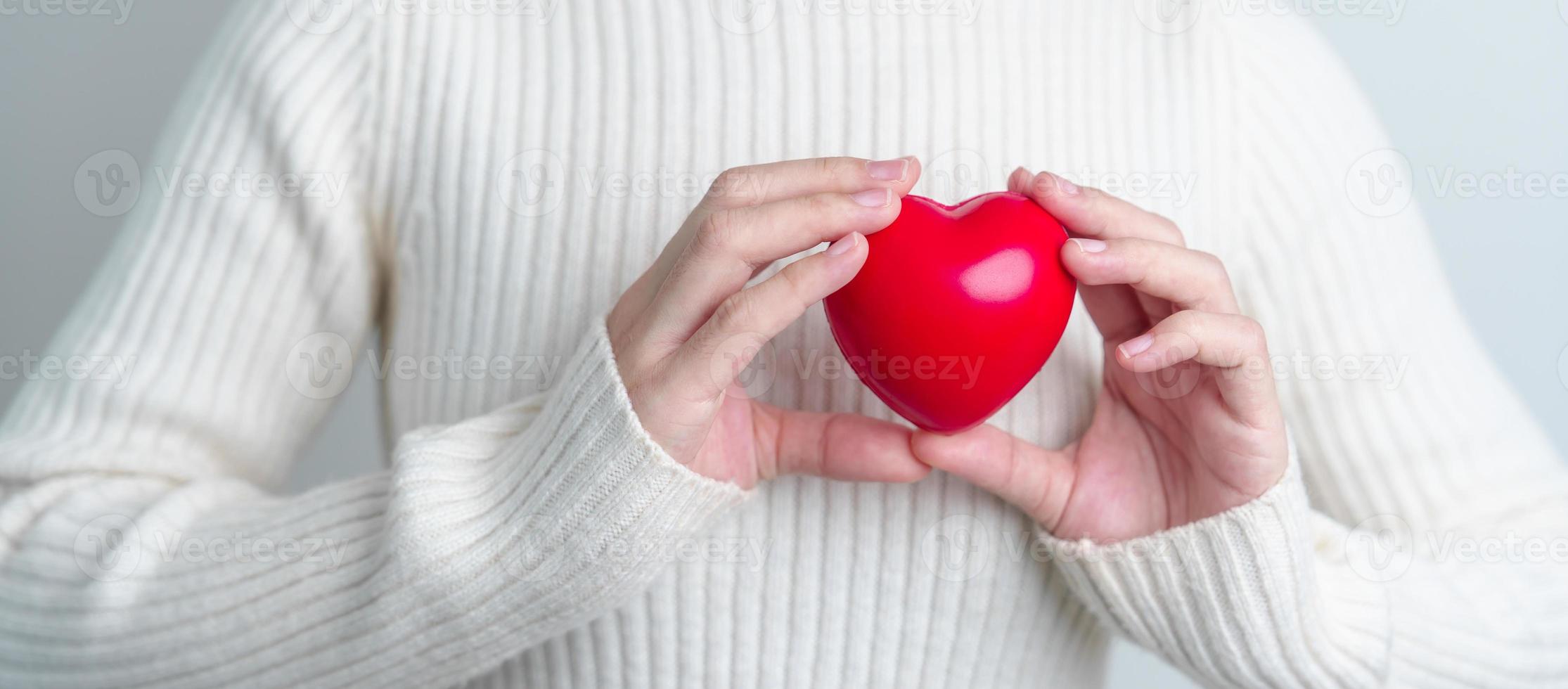 woman hand holding red heart shape. love, donor, world heart day, world health day and Insurance concepts photo