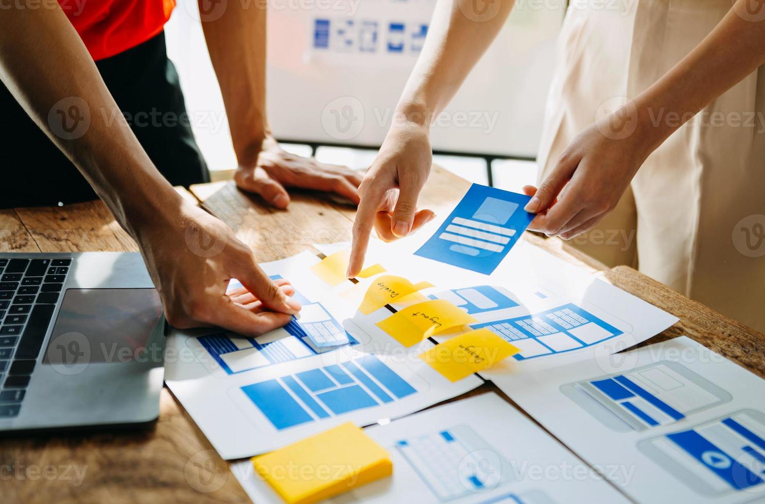 UX developer and ui designer brainstorming about mobile app interface wireframe design with customer breif and color code at modern office. photo