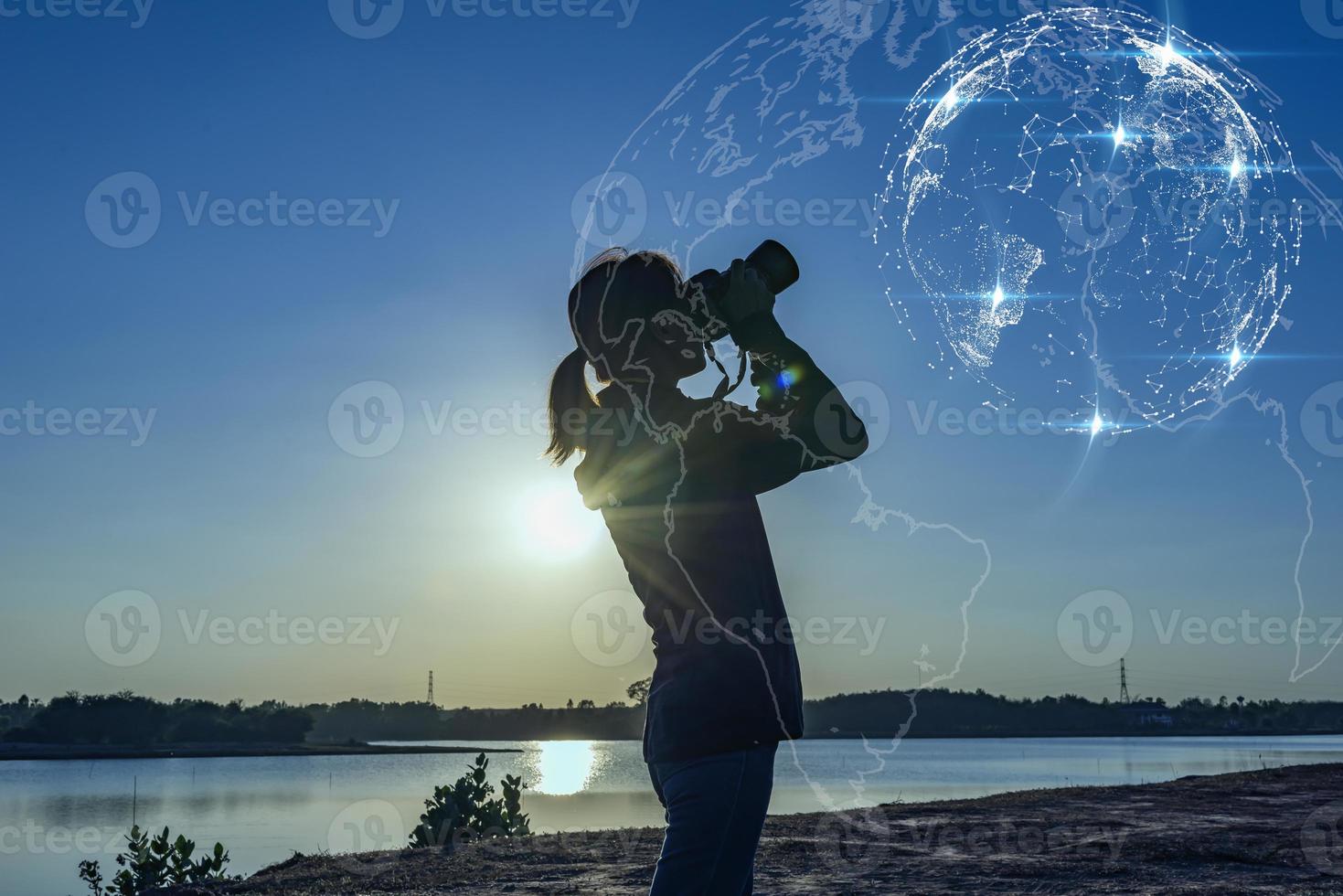 Asian woman holding hands with binoculars Concept of future profitable business pursuit. photo