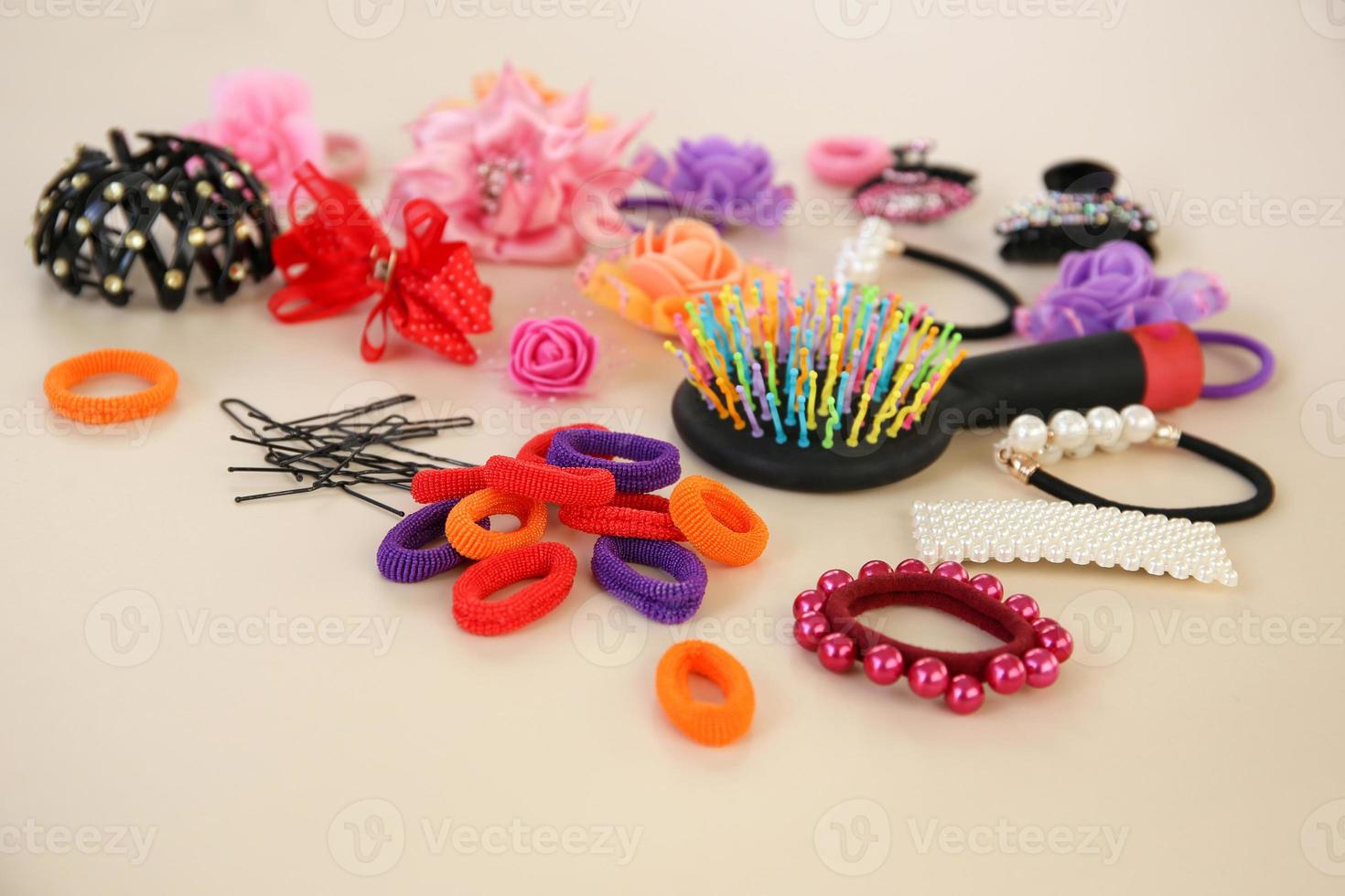Different hair clips on beige background. photo