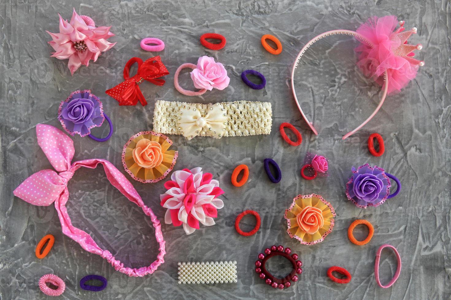 Different hair clips on gray background. Flat lay. Top view. photo
