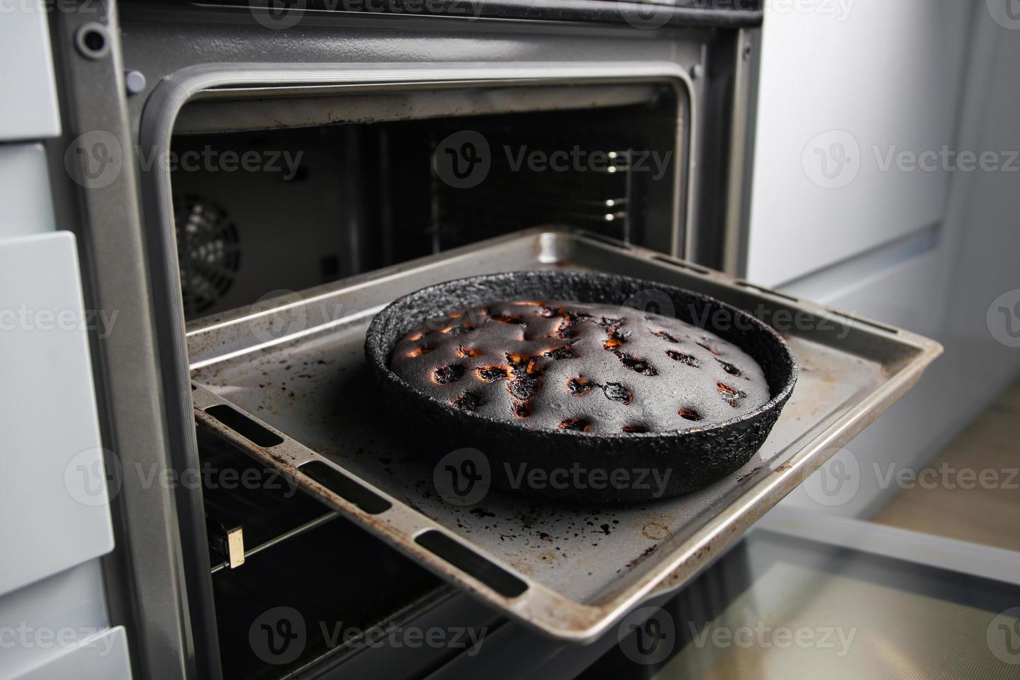 Burnt pie in the oven. photo