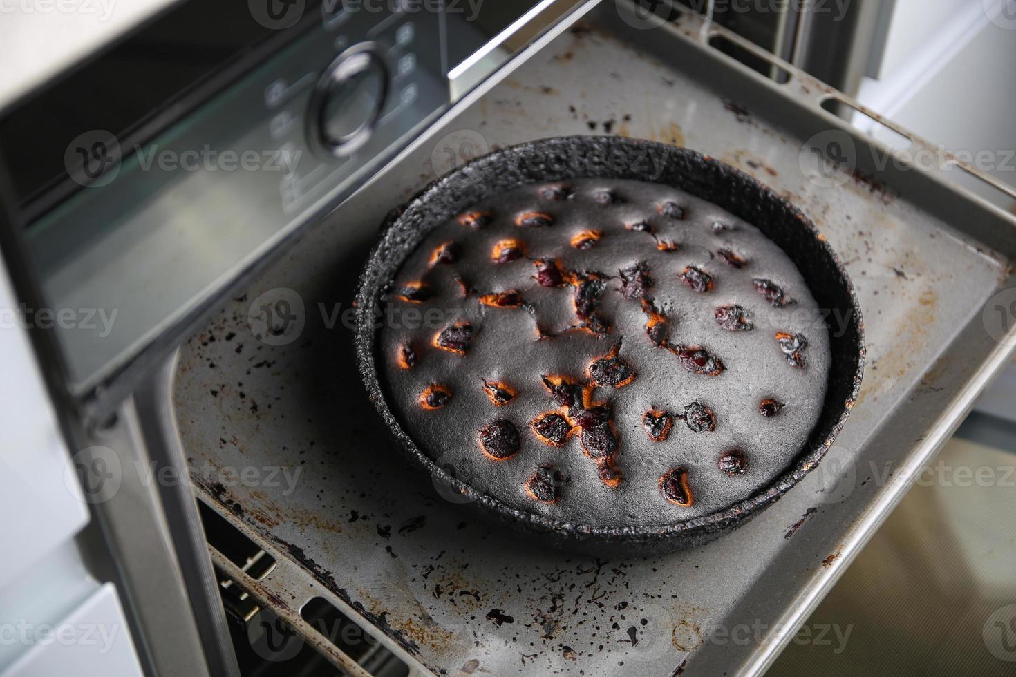 Burnt pie in the oven. photo