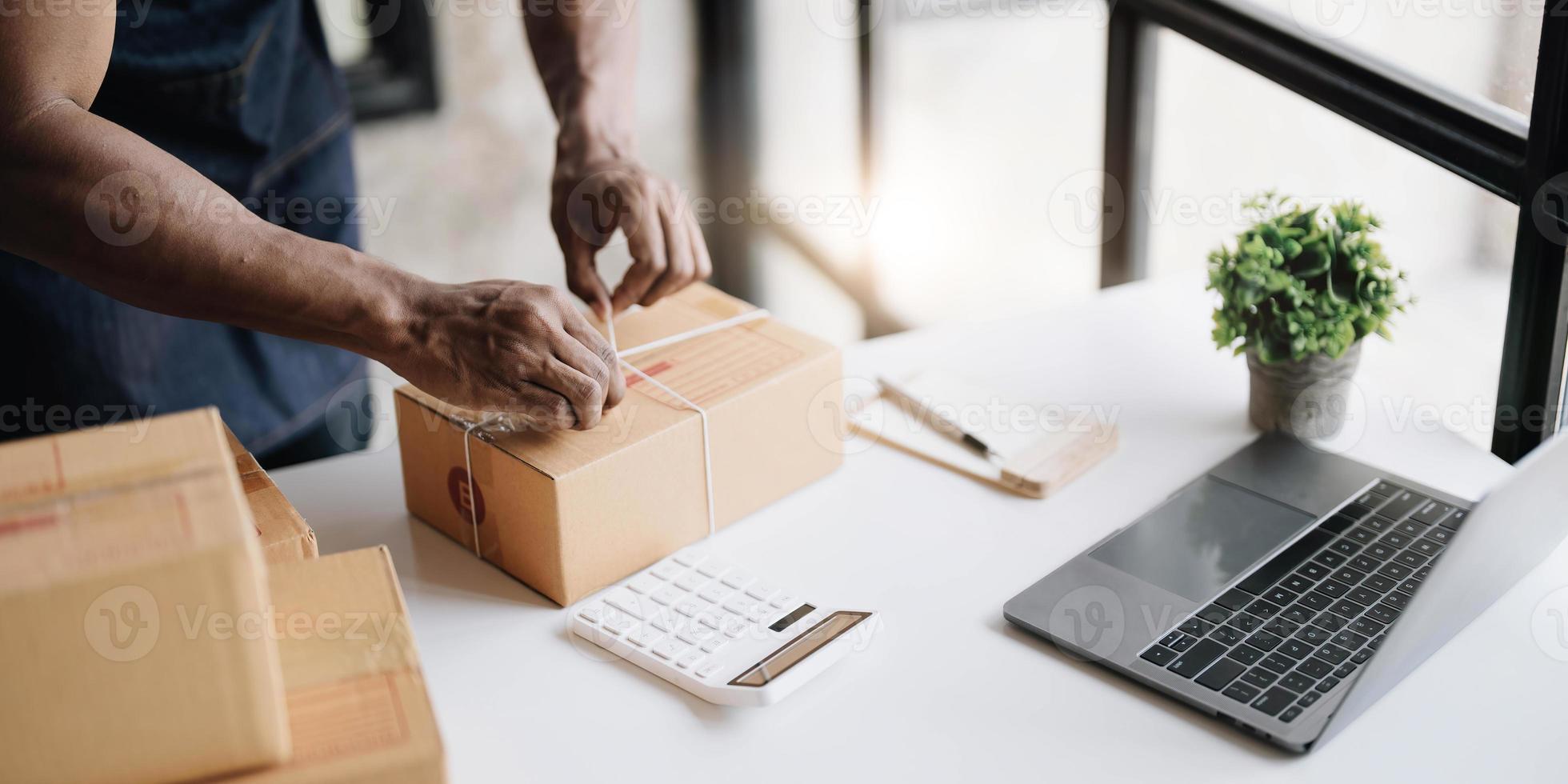 Start up small business entrepreneur SME or freelance asian man working with box at home concept, Young Asian small business owner, online marketing packaging box and delivery, SME concept photo