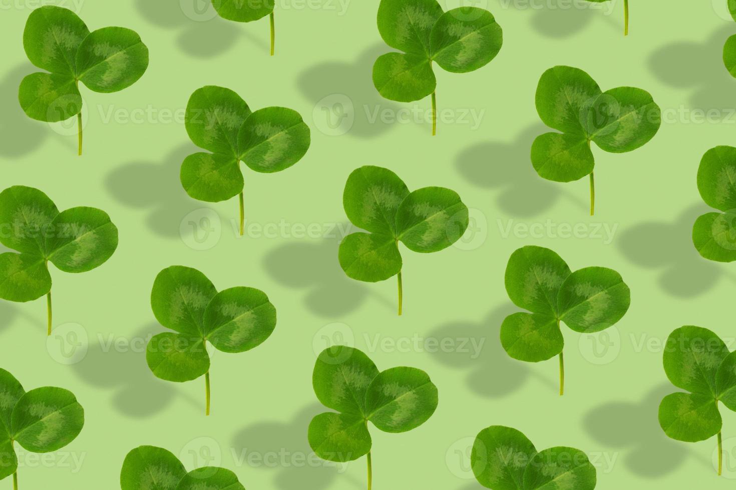 Clover leaf pattern on a green background. Abstract background for St. Patrick's Day photo