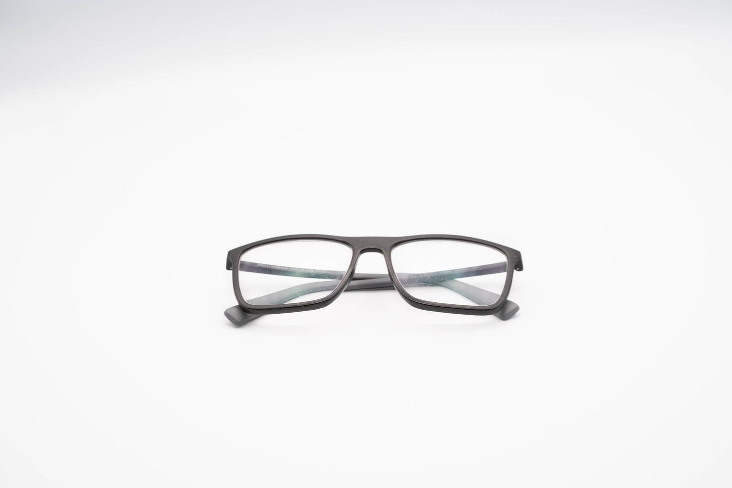 black glasses with a thick rim photographed against a white background, during a photo shoot in January 2023