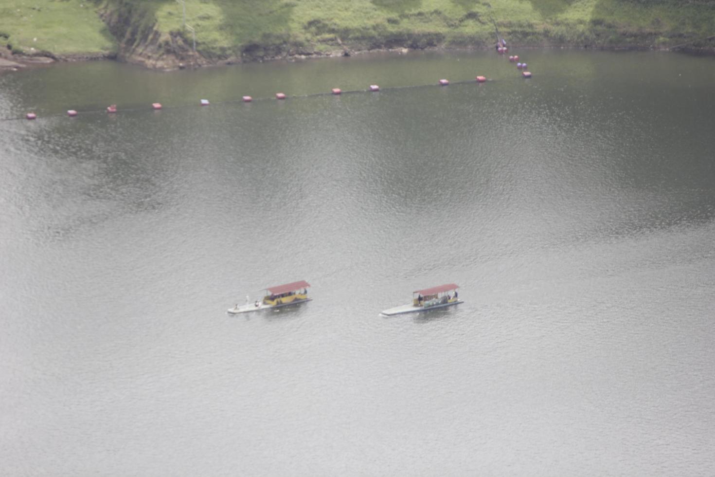 photo of a boat in the middle of a lake during the day