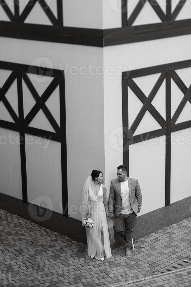 young couple the groom in and the bride on a walk photo