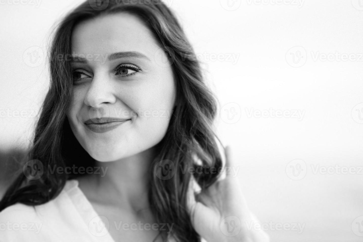 pregnant girl with brown hair on the seashore photo