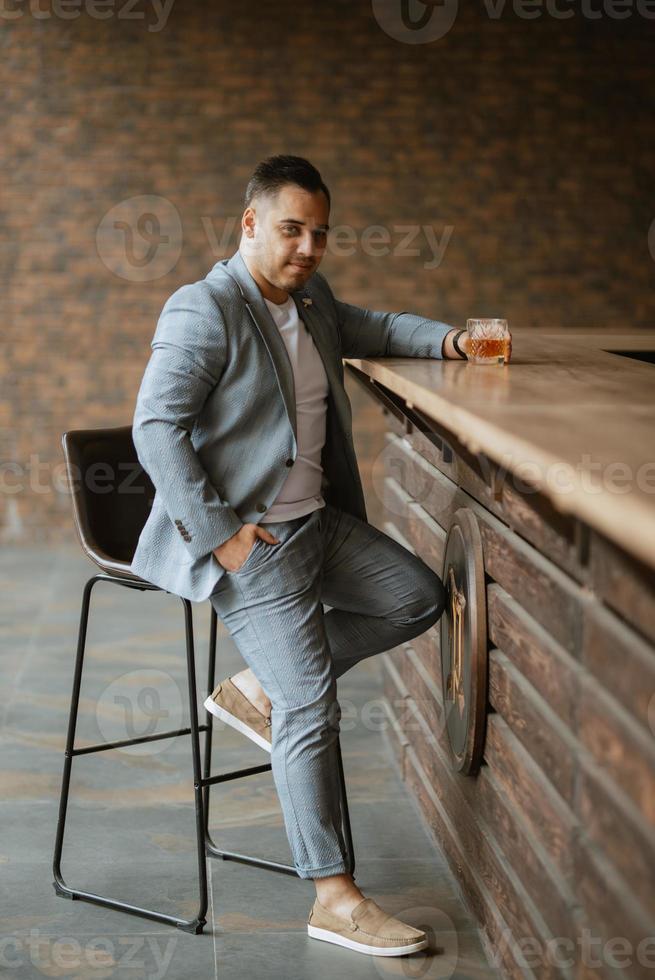 portrait of the groom in a light gray suit photo