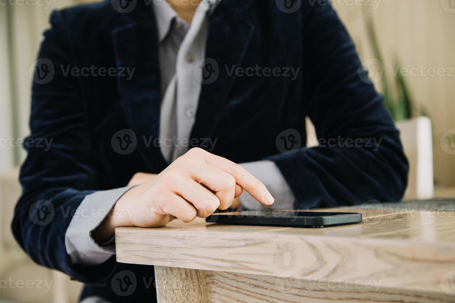 Mature businessman using a digital tablet to discuss information with a younger colleague in a modern business lounge photo