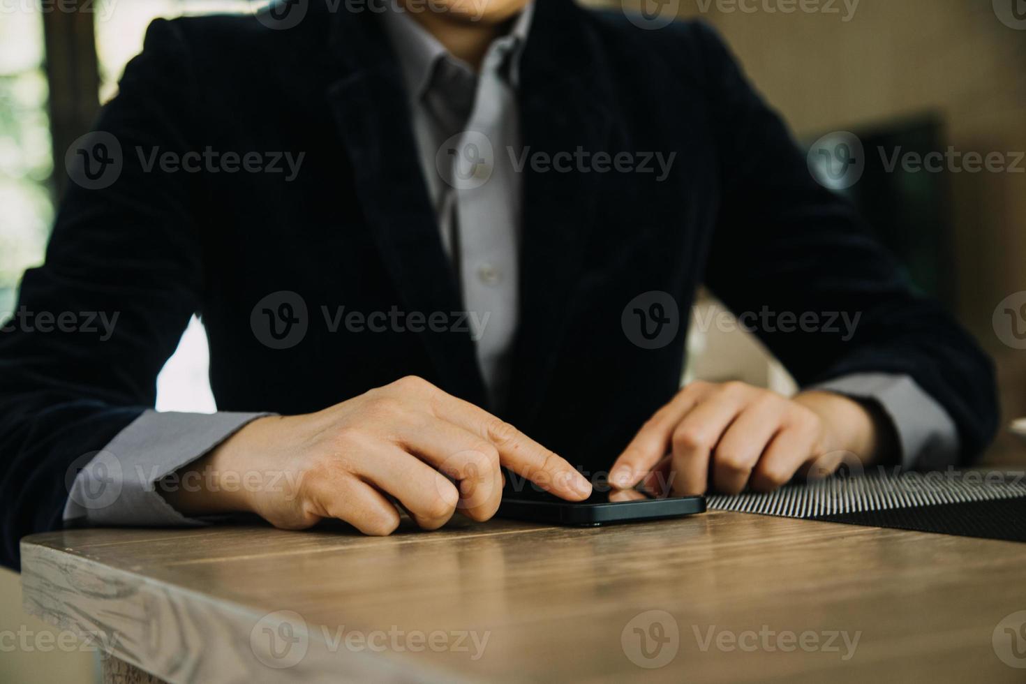 Mature businessman using a digital tablet to discuss information with a younger colleague in a modern business lounge photo