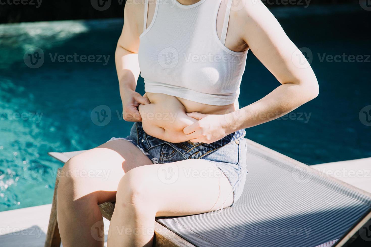fat woman, fat belly, chubby, obese woman hand holding excessive belly fat with measure tape, woman diet lifestyle concept photo