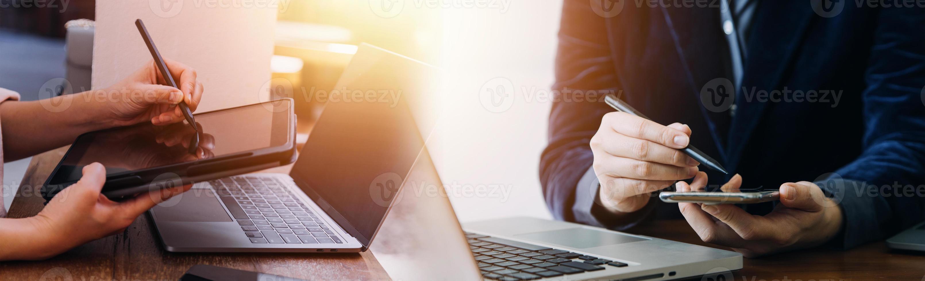 Shot of two businesswoman working together on digital tablet. Creative female executives meeting in an office using tablet pc and smiling. photo