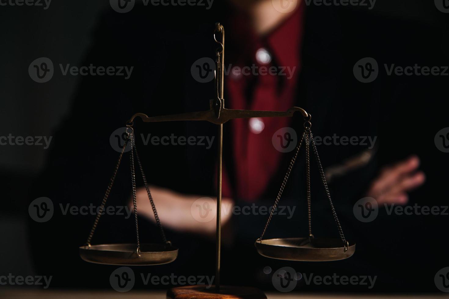 Justice and law concept.Male judge in a courtroom with the gavel, working with, computer and docking keyboard, eyeglasses, on table in morning light photo