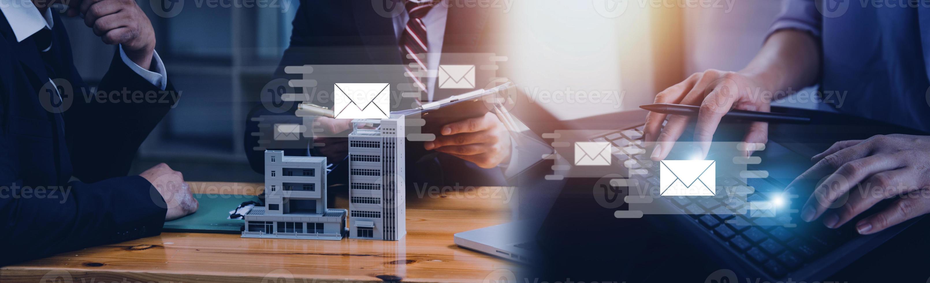 Businessman hands using Laptop typing on keyboard and surfing the internet on office table with email icon, email marketing concept, send e-mail or newsletter, online working internet network. photo