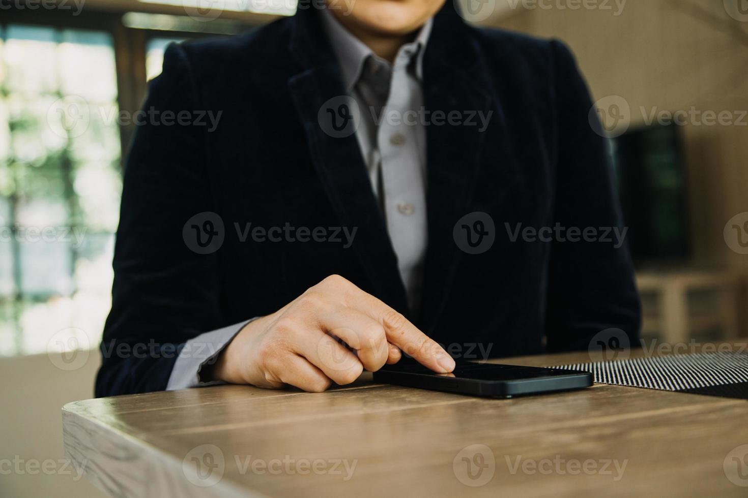 Mature businessman using a digital tablet to discuss information with a younger colleague in a modern business lounge photo