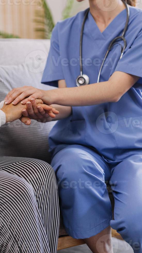 Homecare nursing service and elderly people cardiology healthcare. Close up of young hispanic female doctor nurse check mature caucasian man patient heartbeat using stethoscope during visit photo