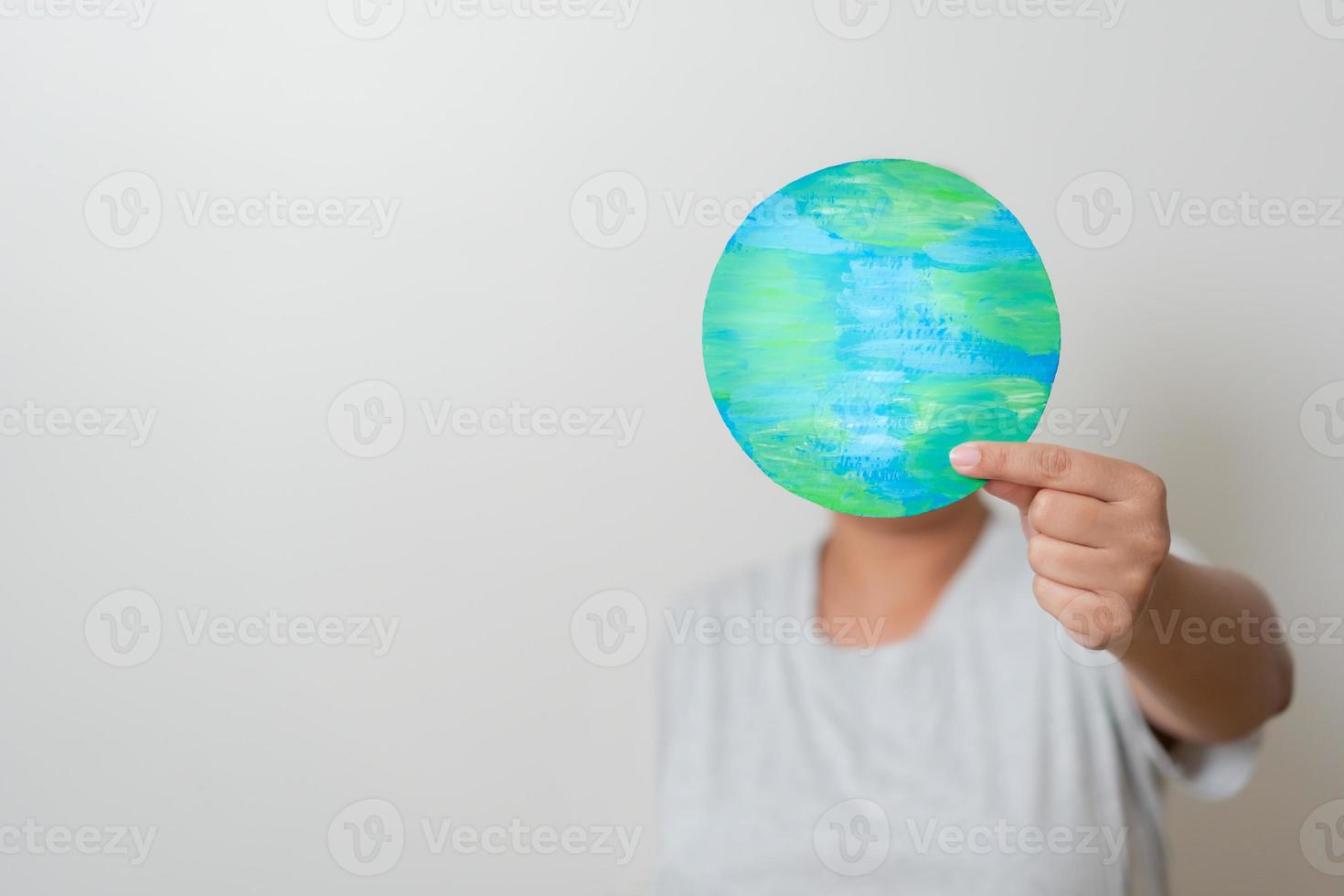 Woman hands holding paper colored earth element to empowered saving the world concept. Love and care to the earth. photo