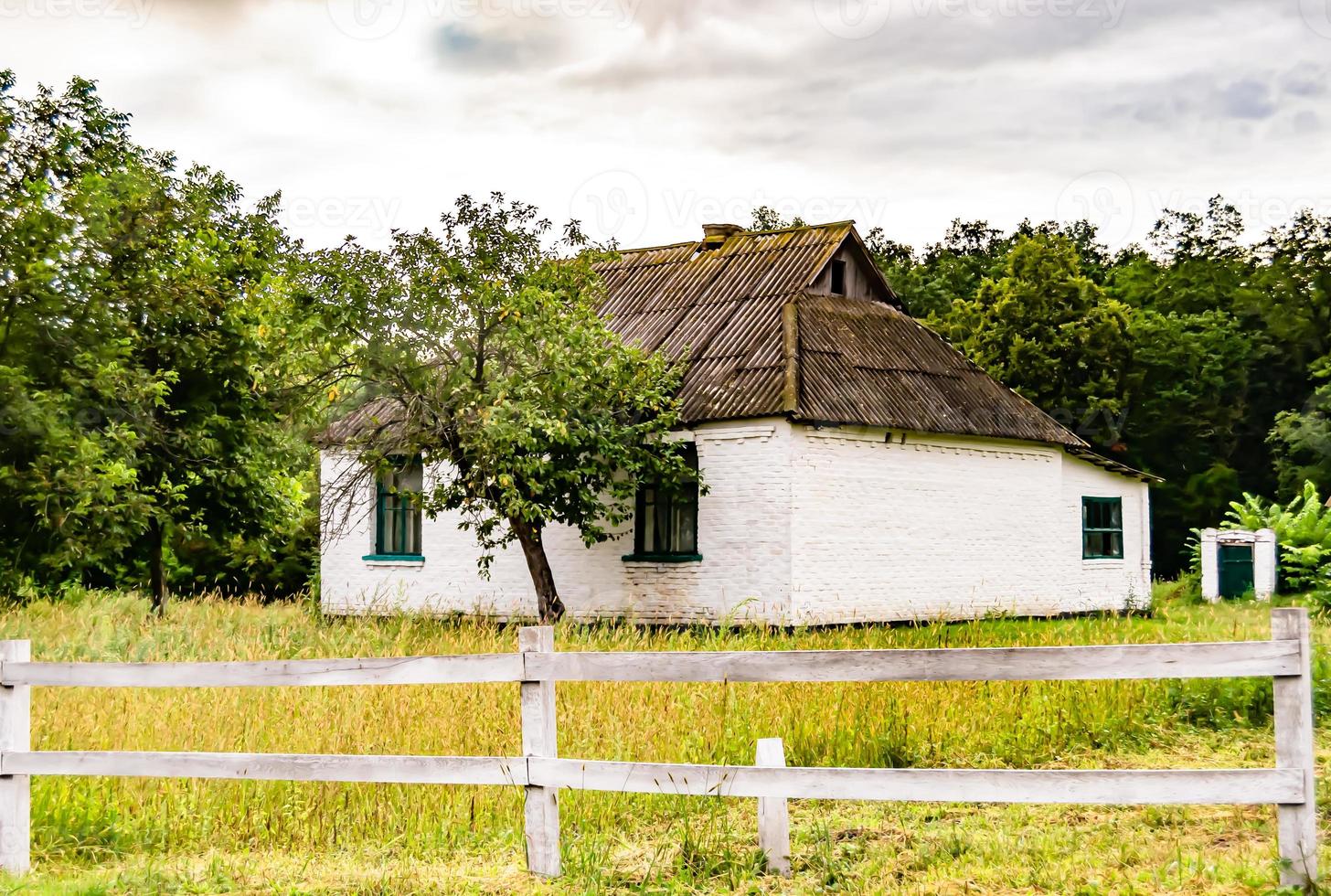 Beautiful old abandoned building farm house in countryside on natural background photo