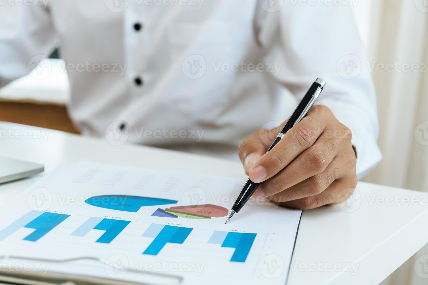 business man working and calculating about finance graph chart with document report on desk at home office, business finance, digital online marketing and financial business, technology concept photo