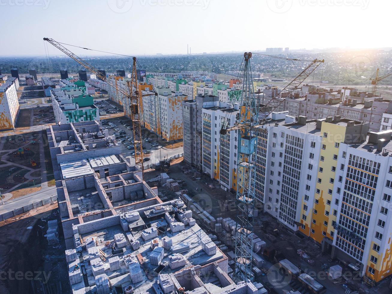Aerial view of construction cranes and new apartment houses. photo