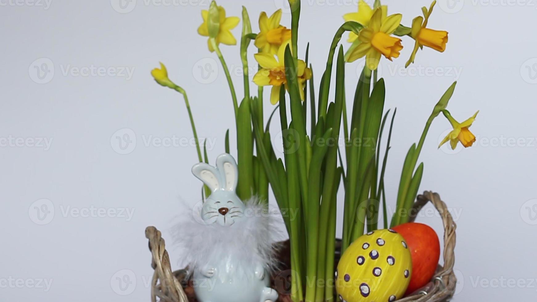 Bouquet of daffodils, Easter eggs and a rabbit. Minimal concept. copy space photo
