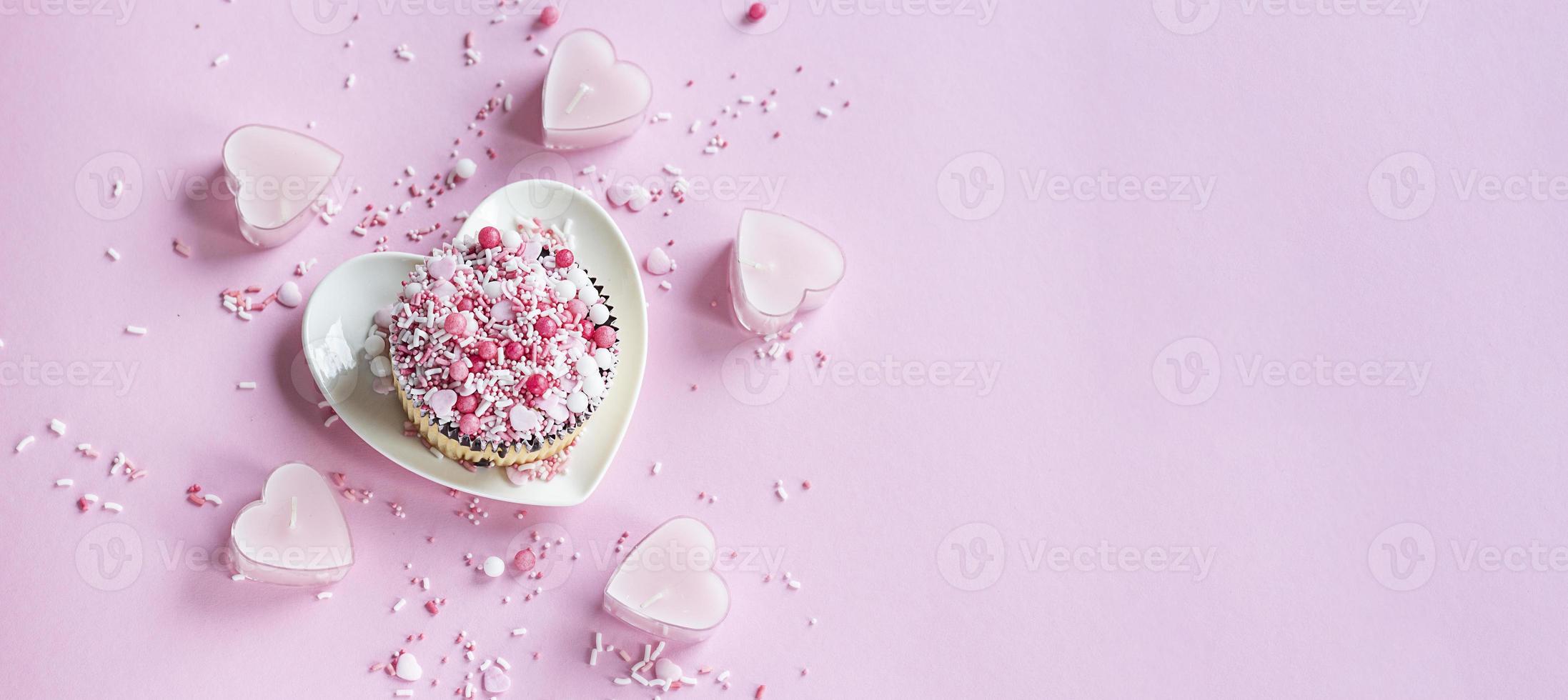 Valentine. Cake on a plate in the shape of a heart on a pink background. Valentine background.  Banner. photo