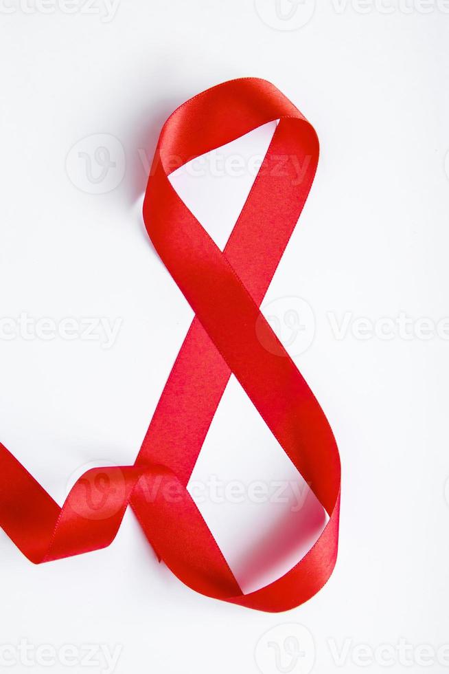 Number 8 from red silk ribbon on a white background. International women's day symbol. Spring holiday on March 8. photo
