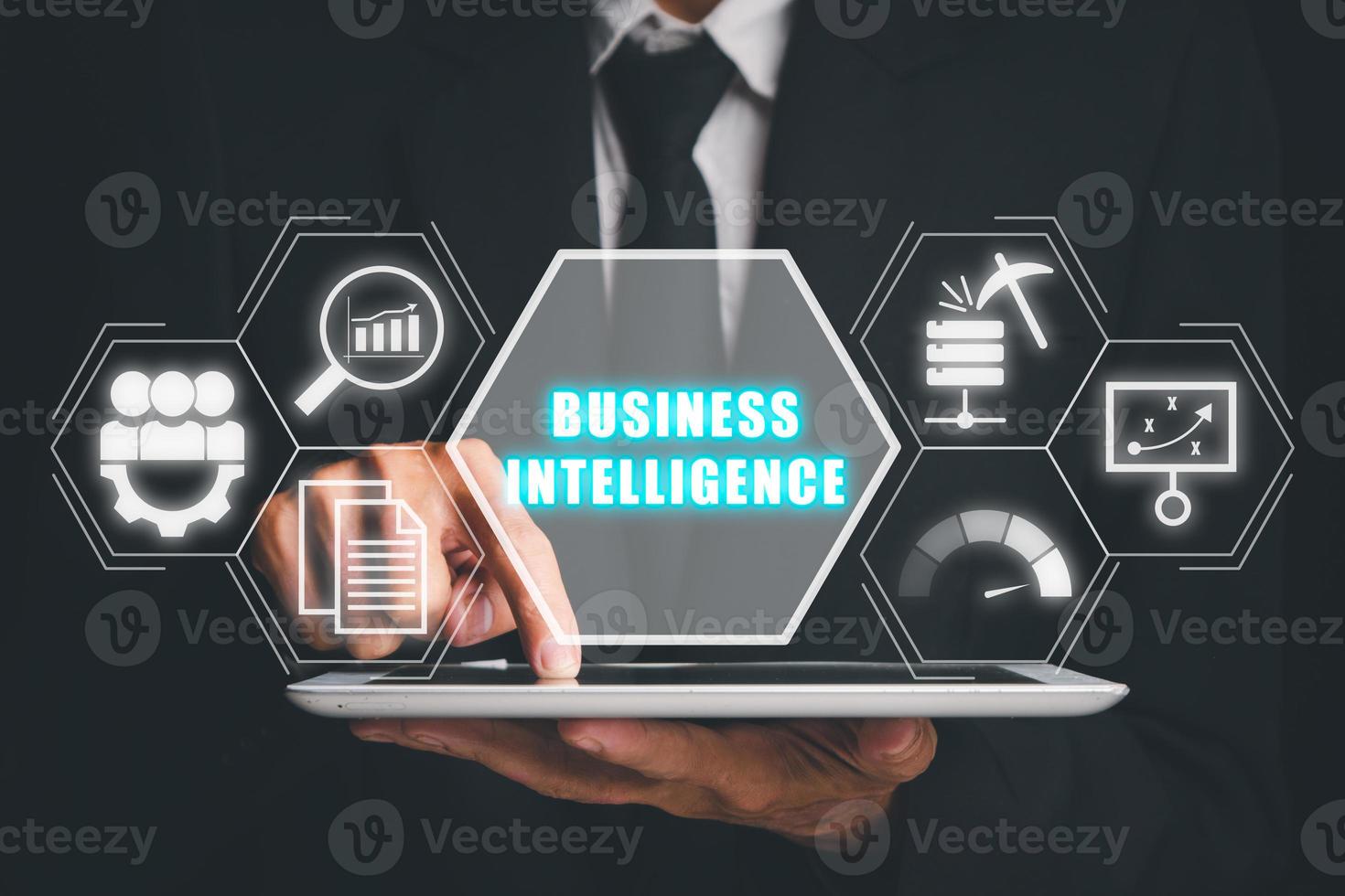 Business intelligence concept, Businees person hand touching digital tablet with business intelligence icon on virtual screen, data mining, analysis, measurement, benchmarking, report and management. photo