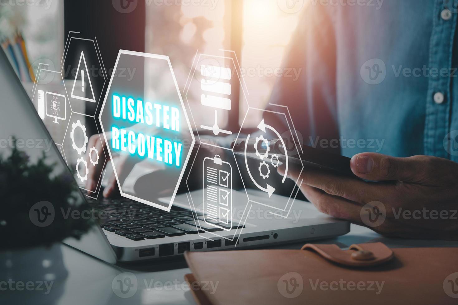 Disaster Recovery concept, Person hand using laptop computer with Disaster Recovery icon on virtual screen. photo