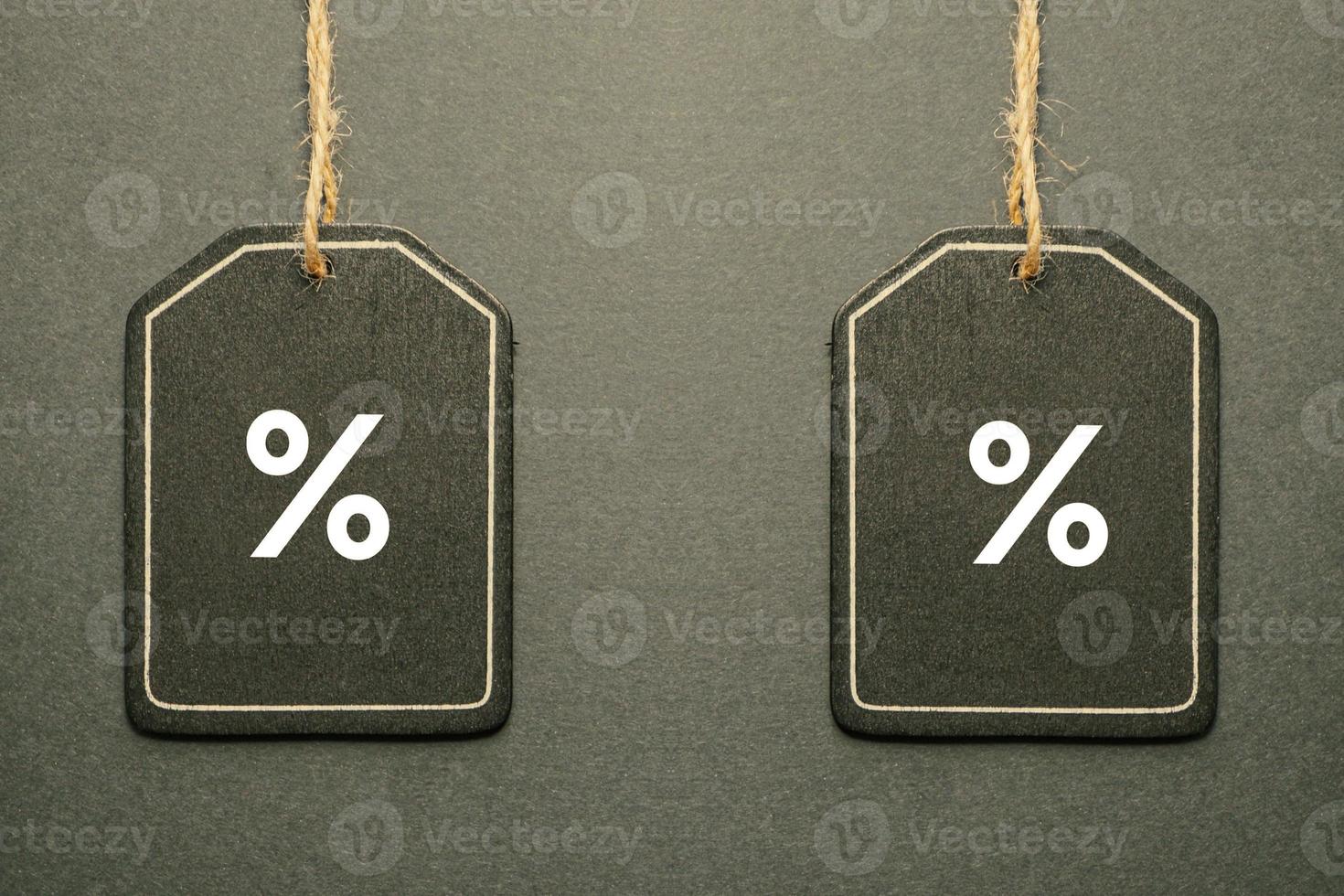 percent sign on the black price tag, black mockup background photo