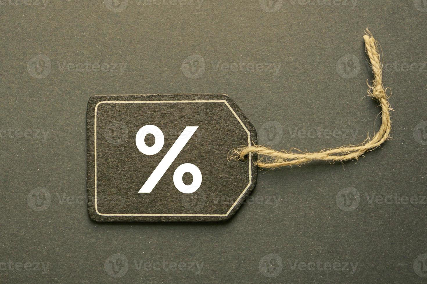 percent sign on the black price tag, black mockup background photo