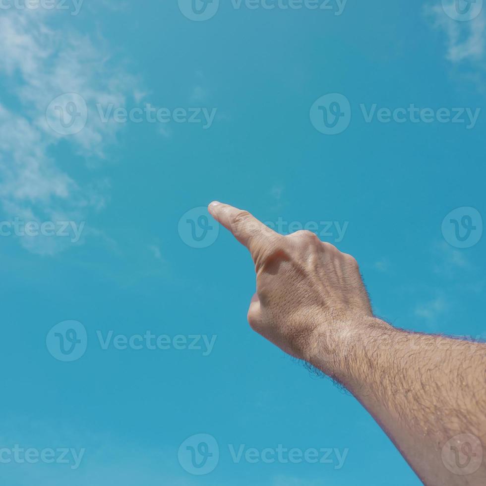 hand up gesturing in the blue sky, feelings and emotions photo