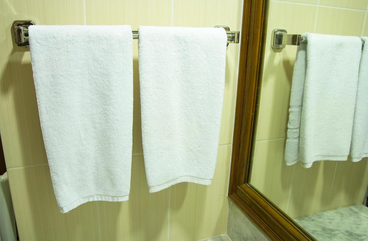 White bath towel hanging in the bathroom photo