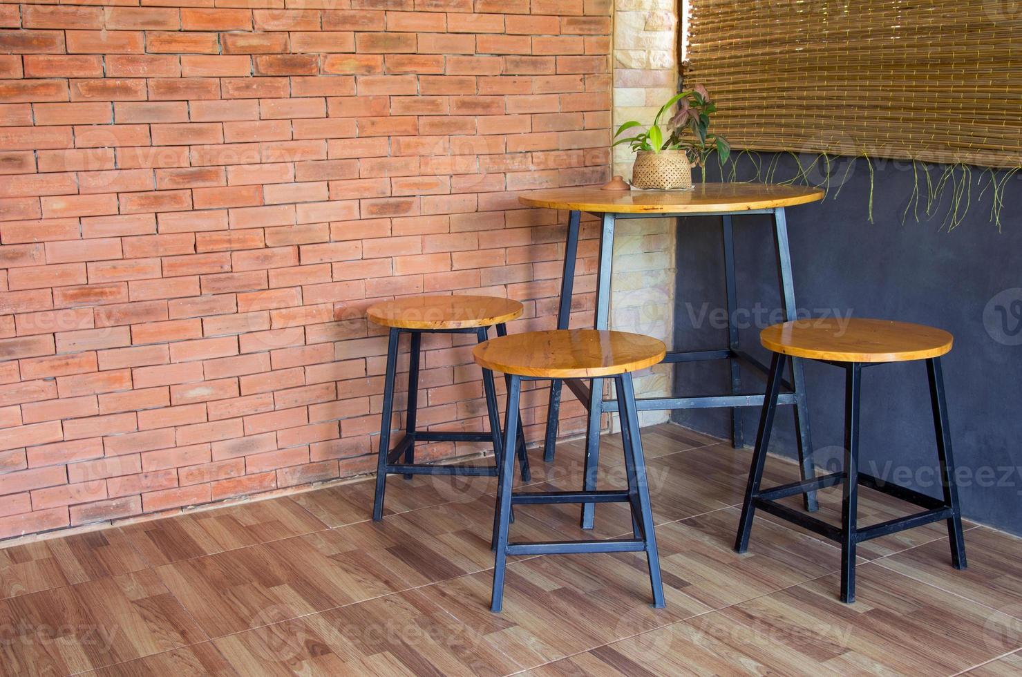 wood chair and table on brick wall photo