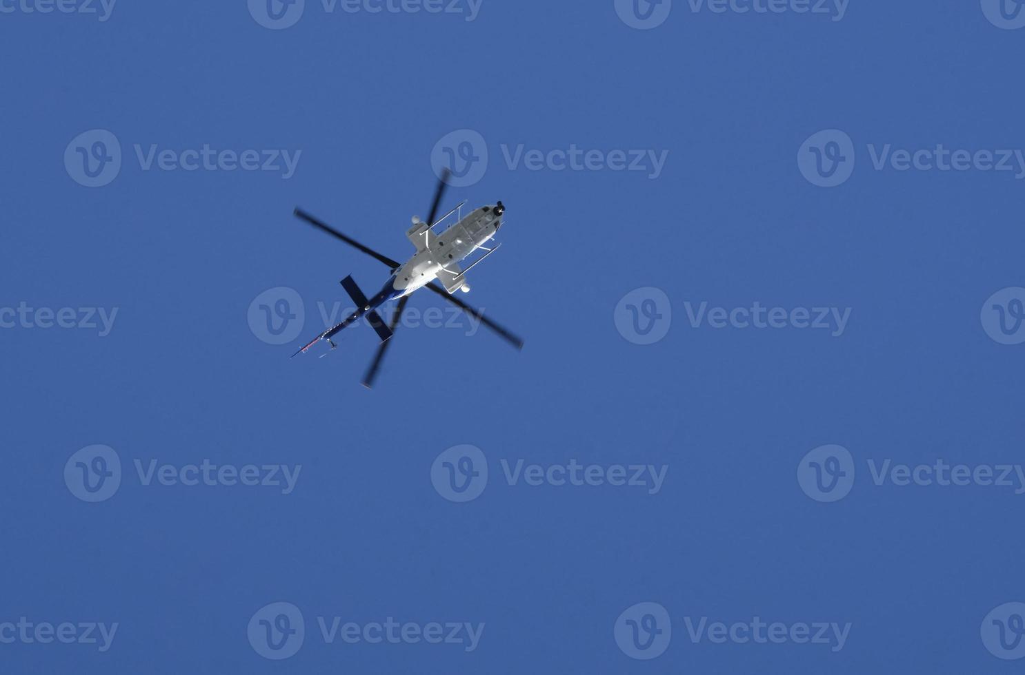Helicopter against the blue sky on a sunny day photo