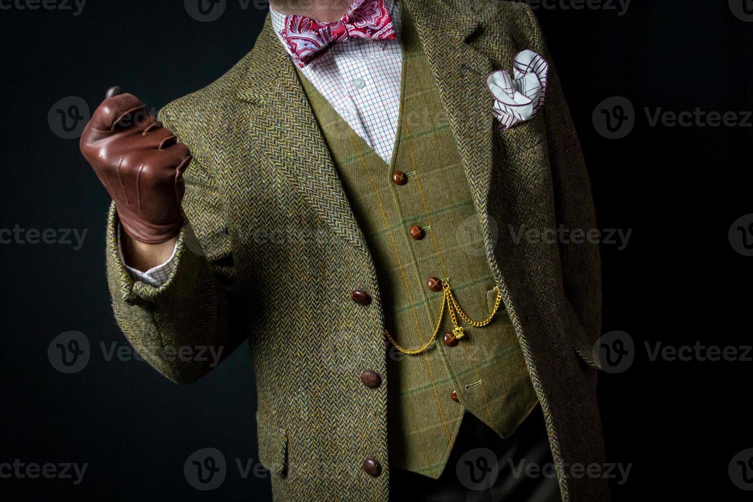 Portrait of Gentleman in Tweed Suit and Leather Gloves Standing Divinely. Concept of Classic and Eccentric British Gentleman photo