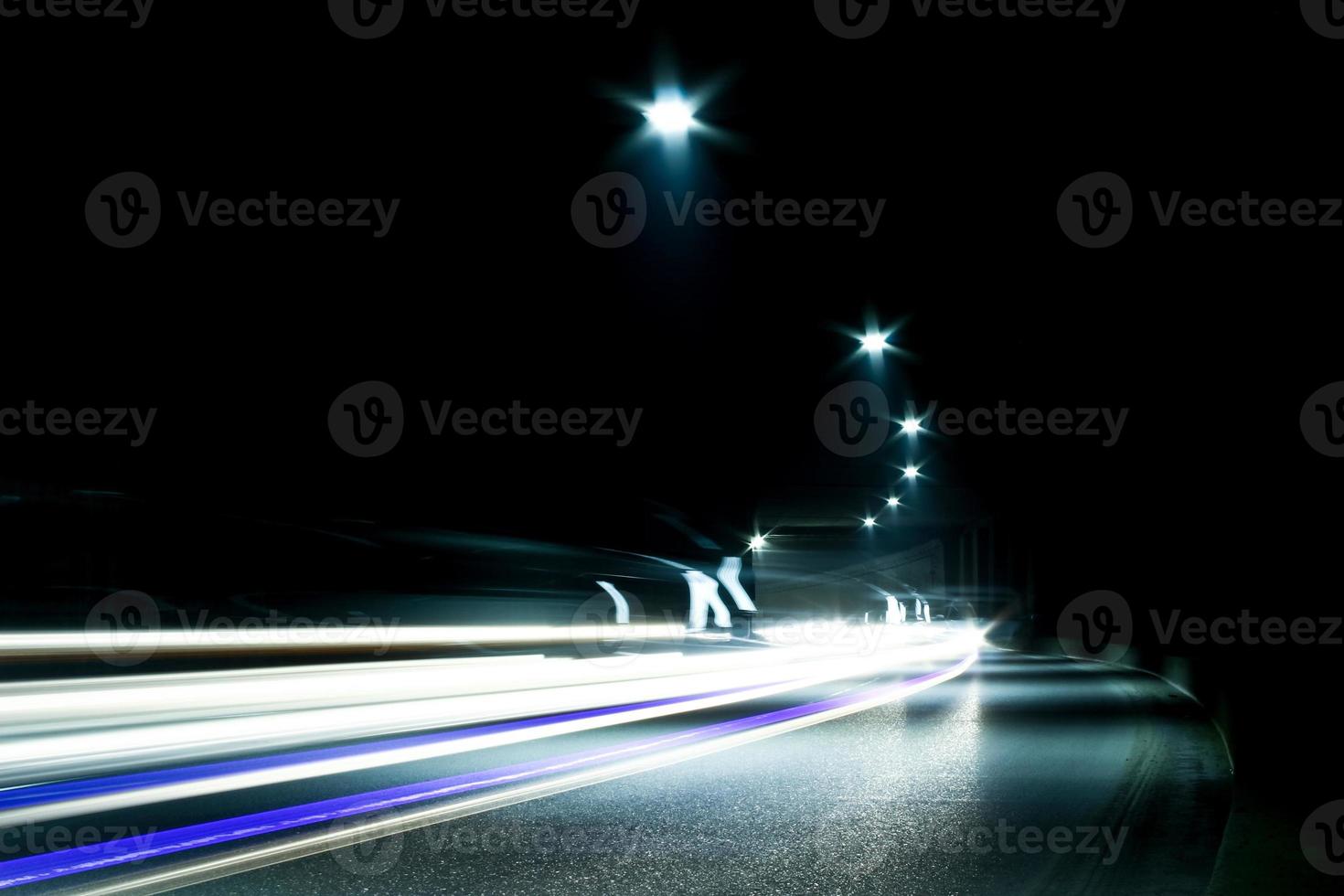 Dark tunnel with moving vehicle. Tunnel with light trails. photo