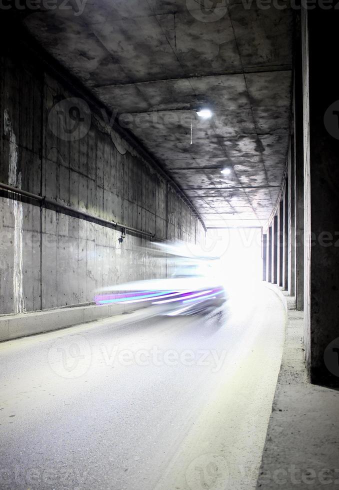 Dark tunnel with moving vehicle. Tunnel with light trails. photo