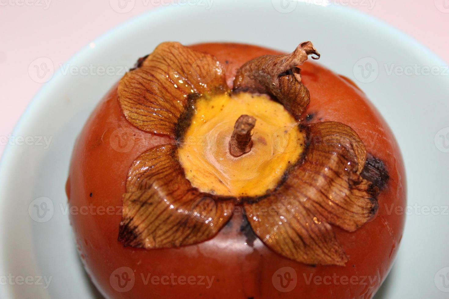 Slices of persimmon.Ripe orange persimmon fruit isolated on white background.Close up of fresh kaki on dark blue.Set of kaki. photo
