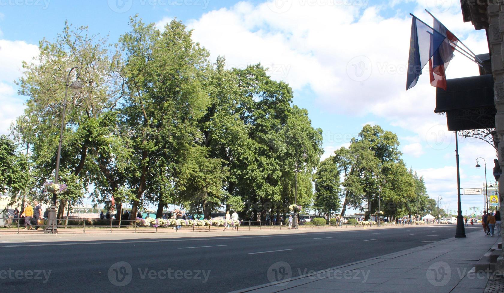 Both sides of the road are planted with street trees. photo