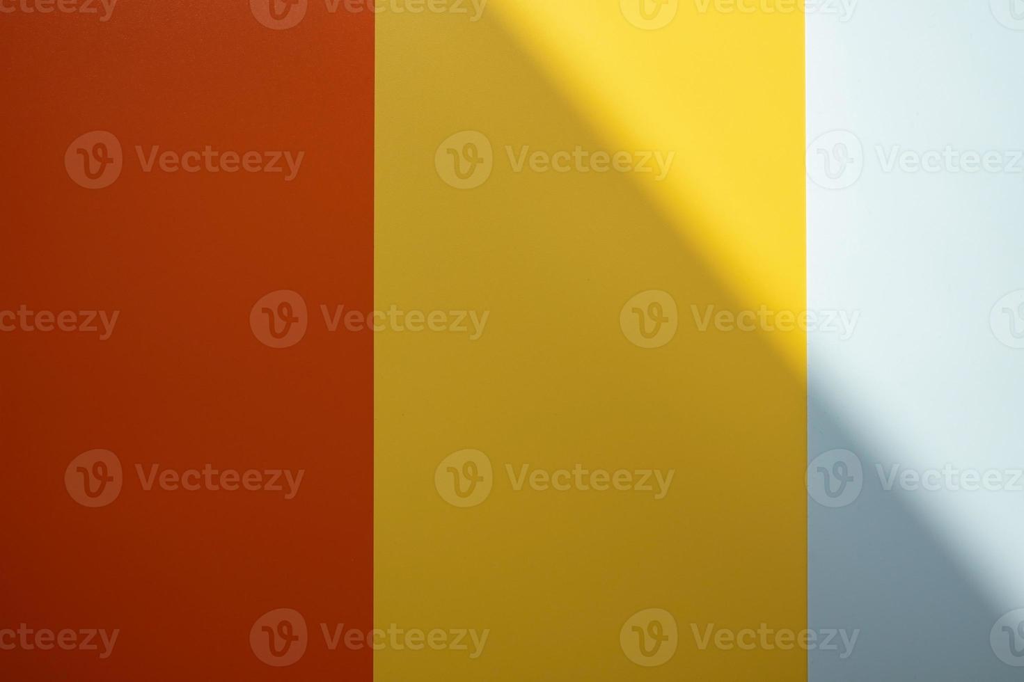 Background of red, yellow and gray colors with a shadow. Colored vertical stripes of different widths. Copy space. photo