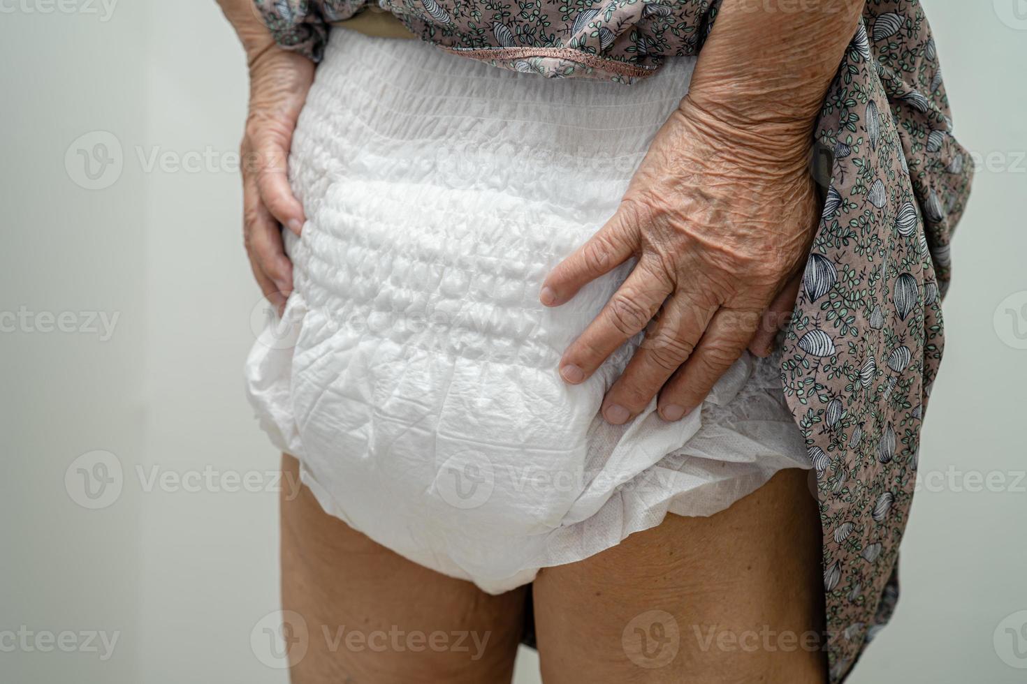 Asian senior or elderly old lady woman patient wearing incontinence diaper in nursing hospital ward, healthy strong medical concept. photo