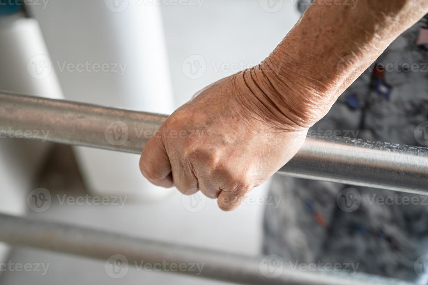 Asian senior or elderly old lady woman patient use toilet bathroom handle security in nursing hospital ward, healthy strong medical concept. photo