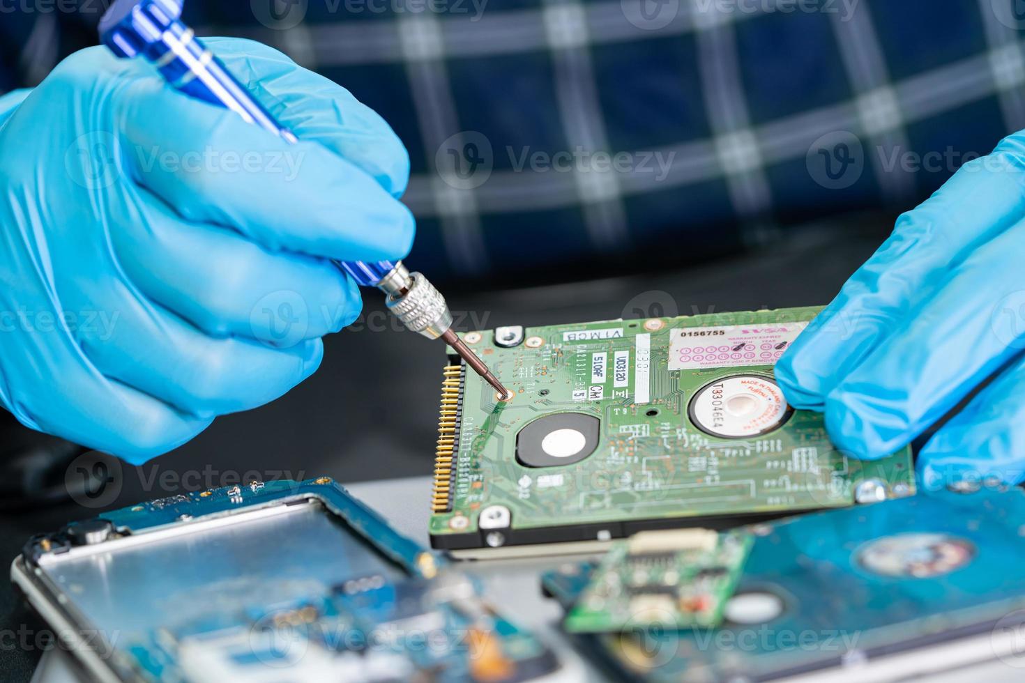 Technician repairing inside of mobile phone by soldering iron. Integrated Circuit. the concept of data, hardware, technology. photo